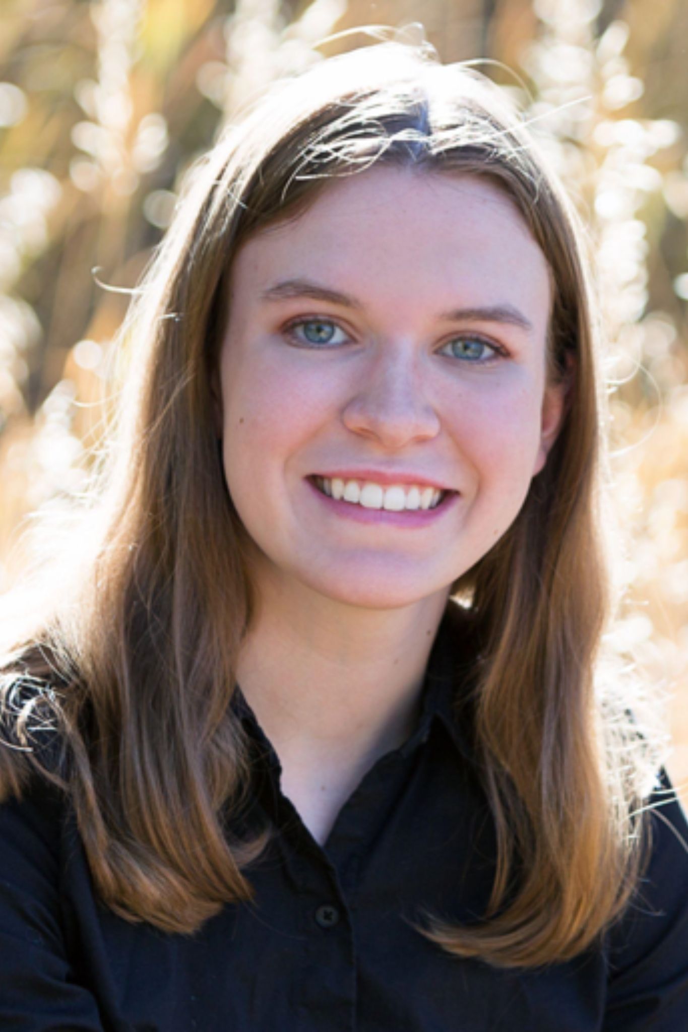 Aimee smiling for a headshot portrait